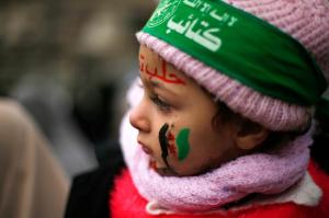 Palestinian girl attends with her mother a protest to show solidarity with trapped citizens of Aleppo, in Gaza